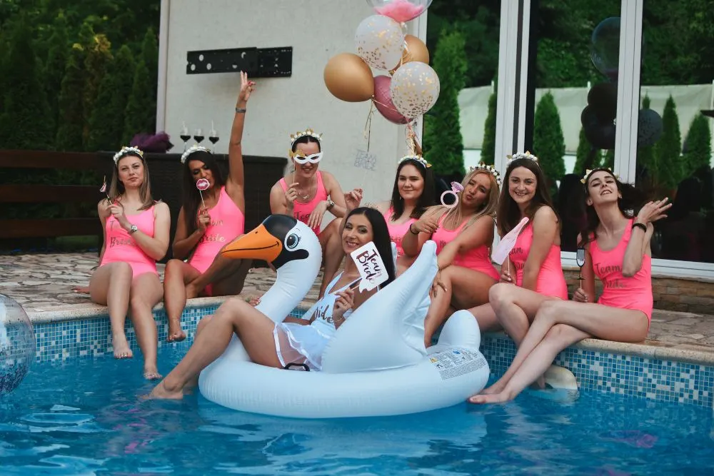 Group of friends celebrating together at a bright resort poolside