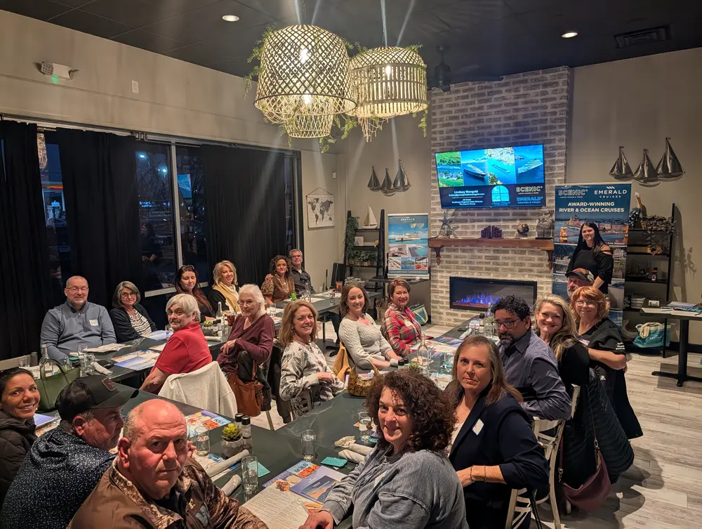 Travelers gathered around the tables at a Your Global Travel Club dinner