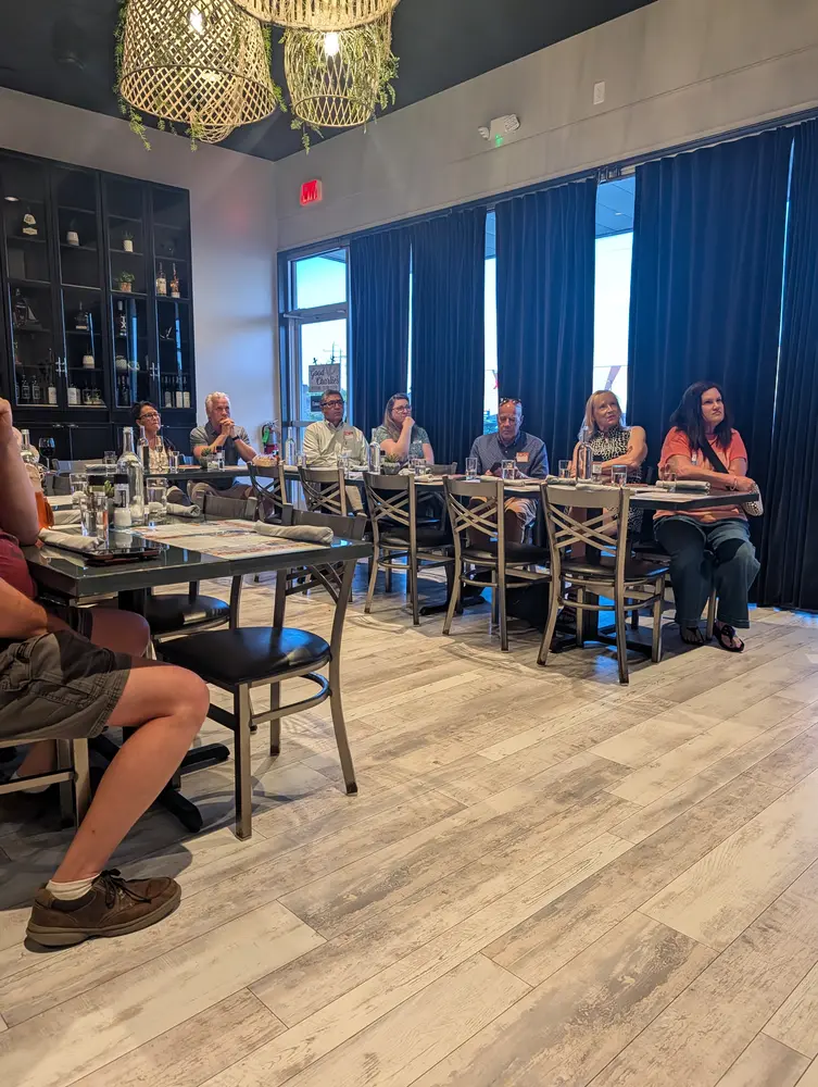 A Travel Club meeting in full swing, travelers seated together