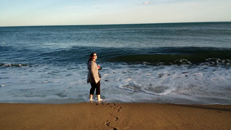 A traveler at the water's edge on Barceloneta beach, Barcelona