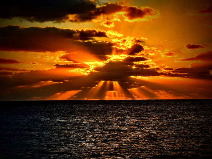 A golden ocean sunset seen from a cruise ship deck