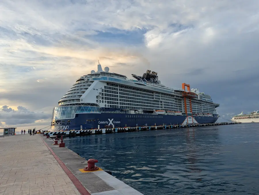 A Celebrity Cruises ship docked at a sunny Caribbean port