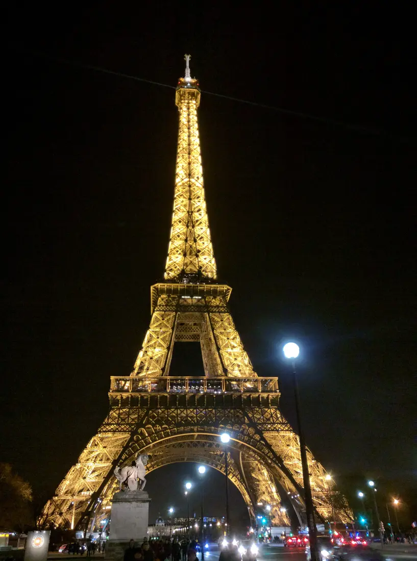 The Eiffel Tower lit gold at night, Paris