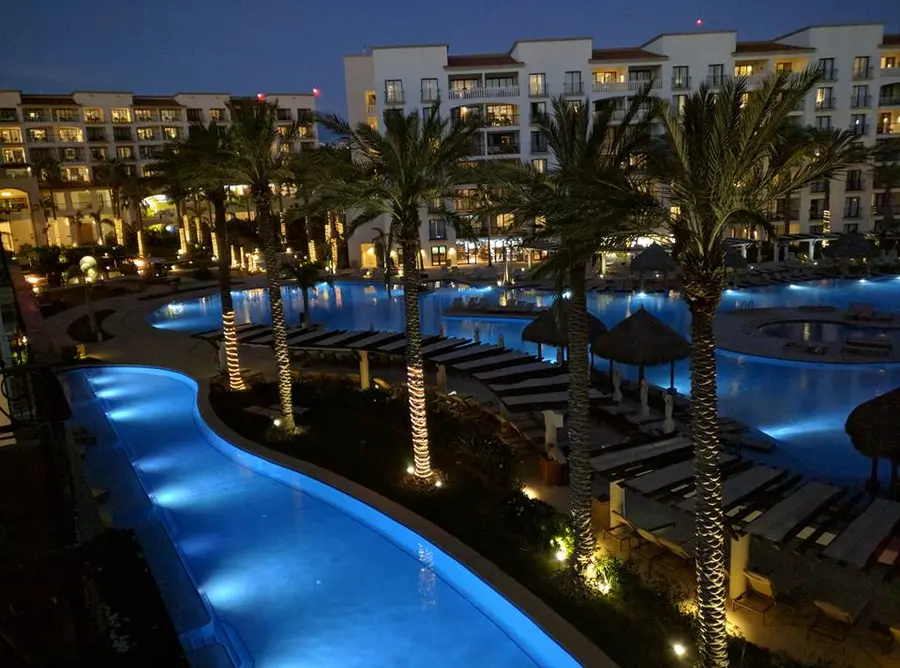 A resort pool glowing at dusk in Mexico