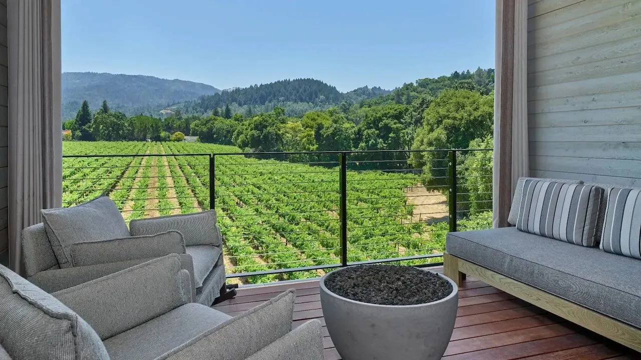 A quiet balcony overlooking rolling vineyards at golden hour